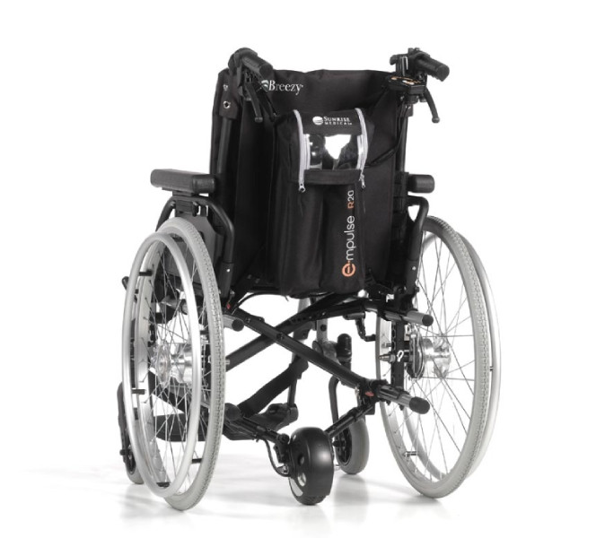 Carer-using-motorised-wheelchair-push-assist Carer using motorised wheelchair push assist